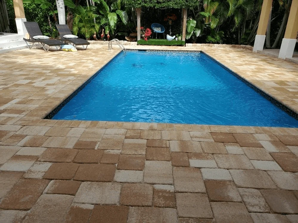A rectangular pool with pavers created by pool deck installers in Palm Beach County, Florida