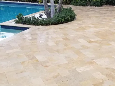 Travertine paver pool deck with a modern swimming pool design